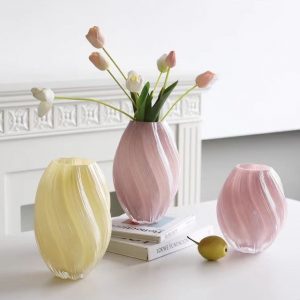Handmade glass cu. vases with pastel pink and yellow finishes, perfect for elegant floral displays.