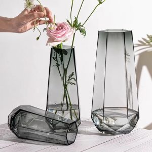 Handmade glass vases with bamboo woven accents, perfect for elegant floral displays. Crafted by Zibo.