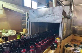 Handmade glass cups arranged in a factory setting, showcasing craftsmanship.