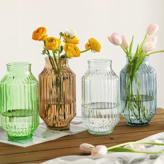 Elegant handmade glass cu. vases with ribbed design, perfect for floral displays and home decor.