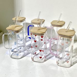 Handmade glass cups with bamboo lids and straws, featuring colorful heart and flower designs. Perfec.