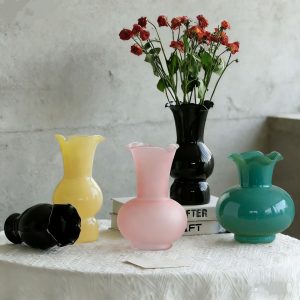 Colorful handmade glass cups with ruffled edges, perfect for home decor or floral arrangements.