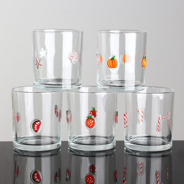 Handmade glass cups with colorful holiday-themed decorations, perfect for festive occasions.